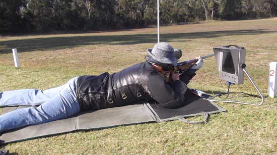 Rifle competitor aiming from the firing point